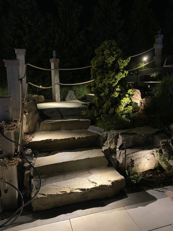 Stone steps lit by landscape lighting
